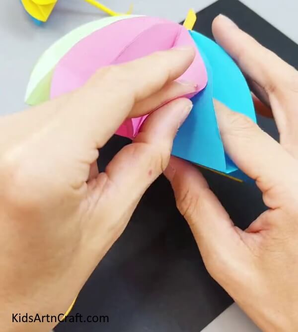 Opening The Quarters To Form an Umbrella - Simple way of making a paper umbrella for kids. 