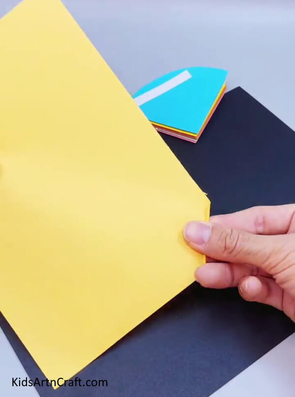 Rolling Over A Yellow Paper - A Paper Umbrella Craft That Is Easy For Children To Do 