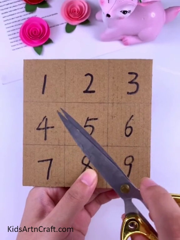 Marking squares and numbers on cardboard sheet- Assembling a Peppa Pig Puzzle Art Piece Step-by-Step