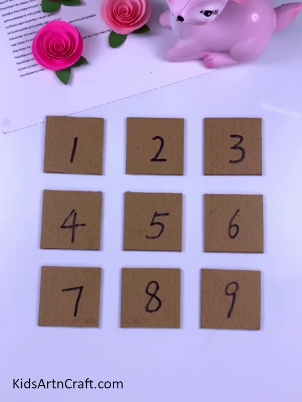 Cutting each squares with scissors- Tutorial for Making a Peppa Pig Puzzle Activity