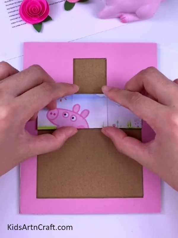 Aligning Peppa pig sticker on puzzle board- Tutorial to Build a Peppa Pig Puzzle Piece