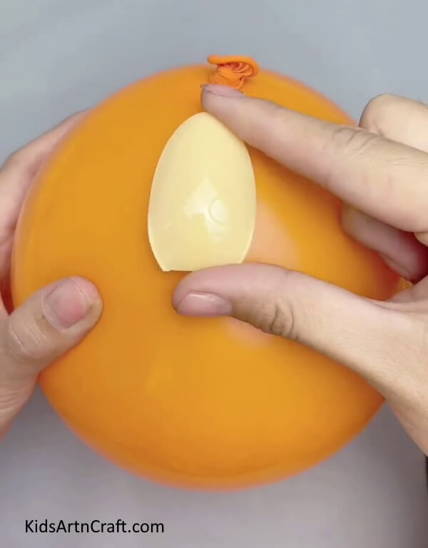Placing The Spoon Bowl Over A Balloon- Step-by-Step Directions for Constructing a Lampshade with Plastic Spoons 