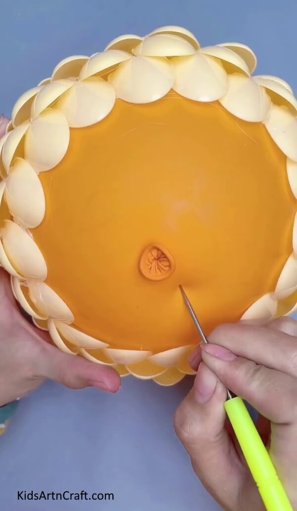 Busting The Balloon- Instructional Guide for Assembling a Lampshade from Plastic Spoons 