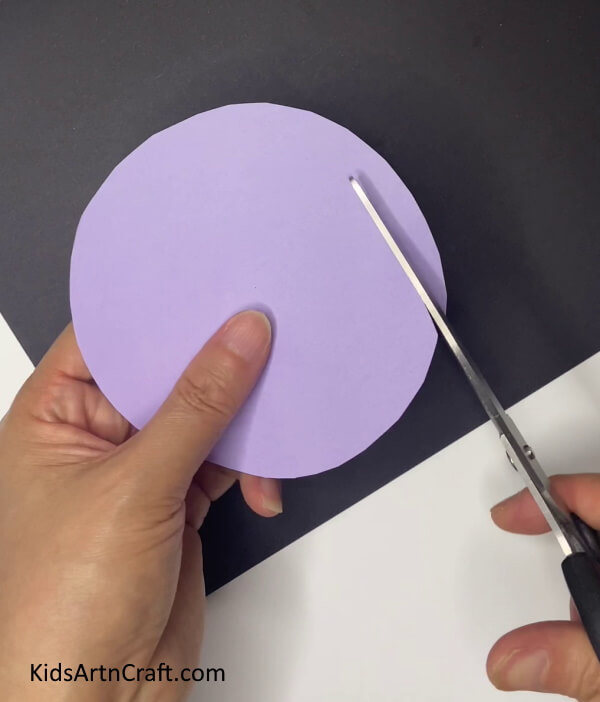 Cutting A Purple Circle Learning to Craft a Lavender Blossomed Paper Plant With Foliage