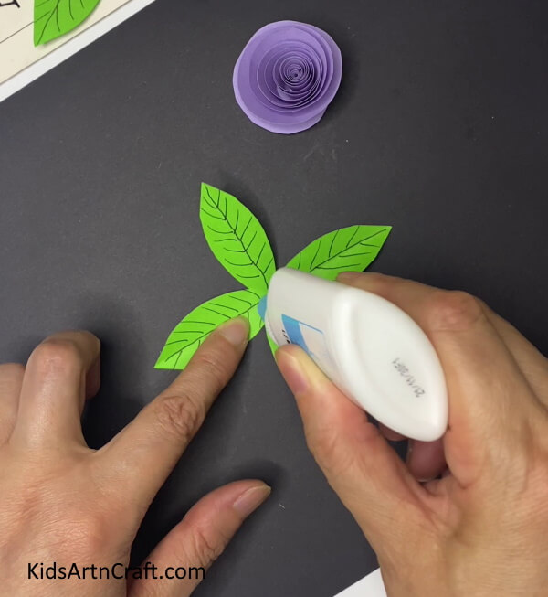 Adding Glue To The Center Of The Leaves Steps for Constructing a Plum Paper Flower With Leaves