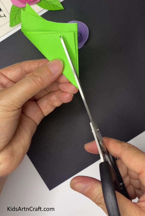 Cutting Petal Shape From The Green Paper Instructions for Making a Mulberry Paper Flower With Leaves