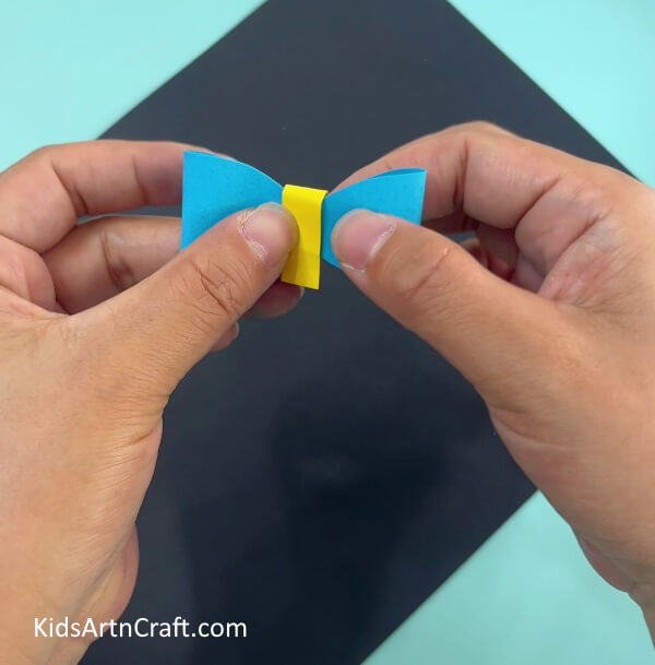 Adding A Yellow Strip To Bow- Making a Paper Bag with a Shirt and Bow Using Origami at Home