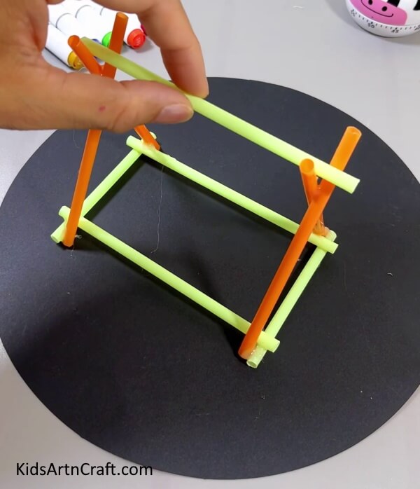 Sticking A Straw Over Both The Triangles - A Constructive Straw Swing Tutorial For Kids To Create