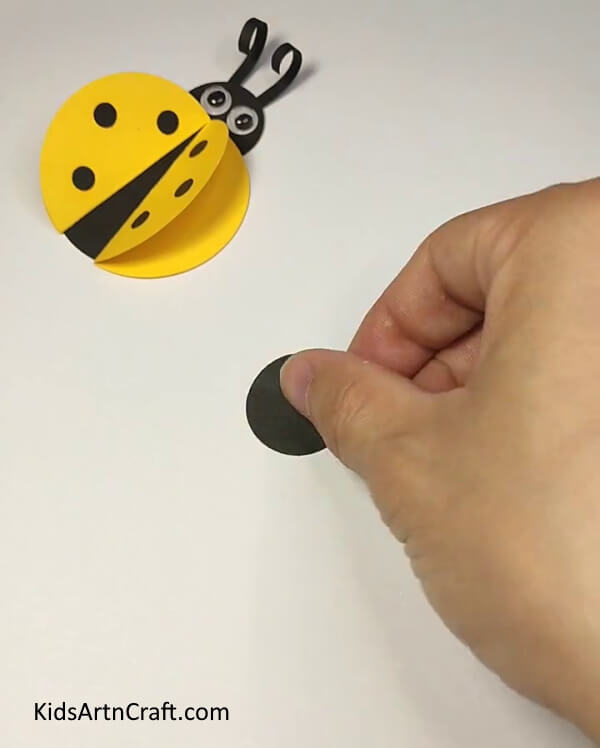 Starting With A Black Sheet Of Paper-This is a straightforward project to make a ladybug paper ring for kids. 