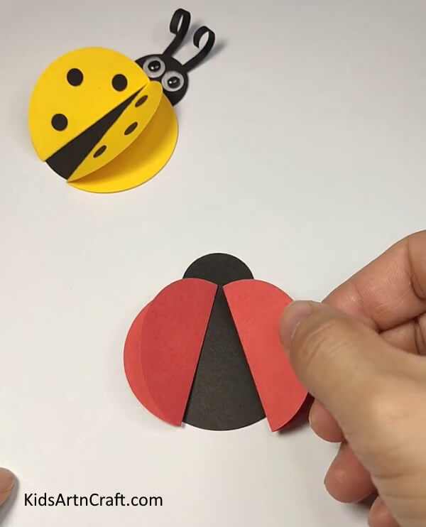Cutting More Shapes Out Of The Sheet-Easy instructions to craft a ladybug paper ring for kids. 