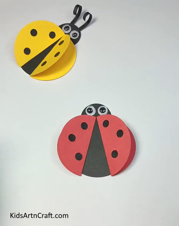 Pasting The Pair Of Googly Eyes-Instructions for kids to make a ladybug paper ring without difficulty. 