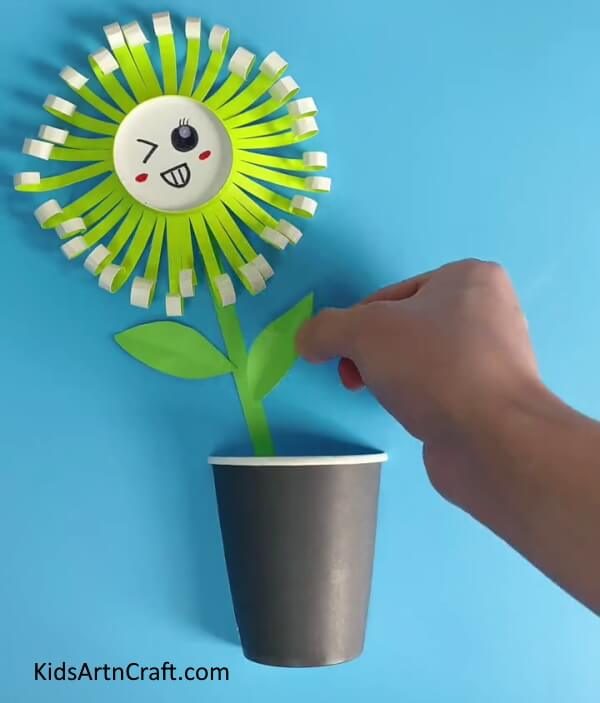 Pasting The Leaves-Guide your little ones in forming a Paper Cup Flower
