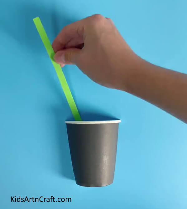 Pasting A Green Stem-Teach your children how to create a Paper Cup Flower
