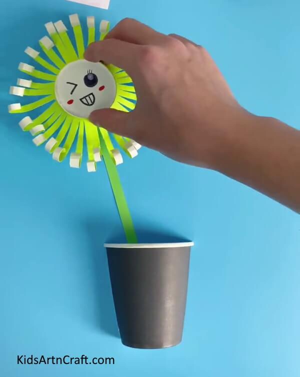 Pasting A Flower On The Stem-Instruct your youngsters to create a Paper Cup Flower