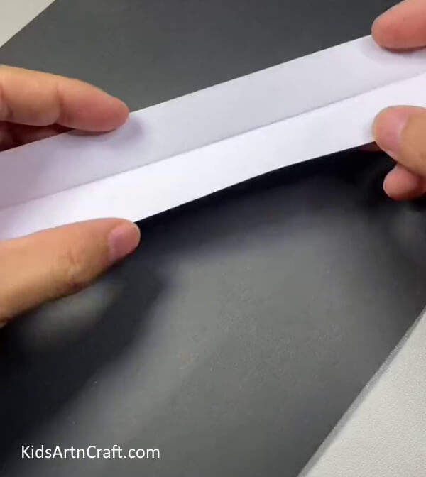 Cutting The Sheet Of Paper-A Step-by-Step Guide to Making Bunny Finger Puppets for Kids