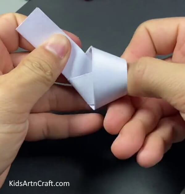 Making A Knot On The Strip-A Simple Guide to Creating Bunny Finger Puppets for Kids