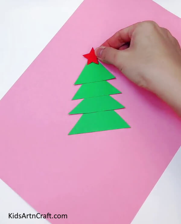 Adding Red Star On The Top - Educate your youngsters in the art of making Christmas tree decorations.
