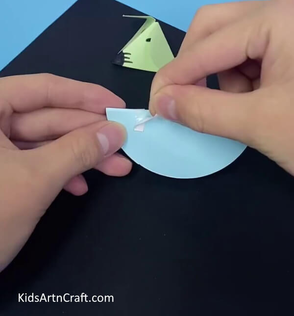 Stick thin double sided tape on blue craft paper- Acquiring the aptitude to form an effortless Paper Mouse Craft for minors 