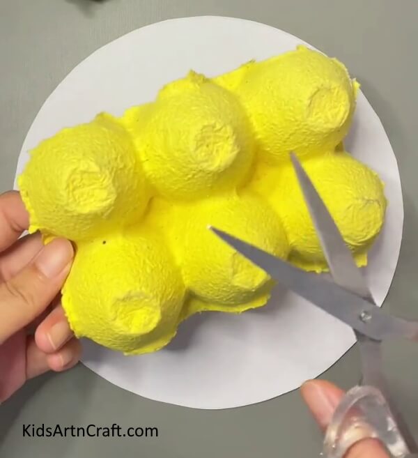 Separating Egg carton into individual pieces- Discover how to craft Egg Carton Blossoms with the Bees Tutorial