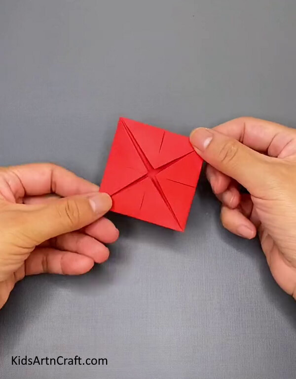 Make Similar Folds From All Four Sides of the Craft Paper- Discover the technique of fashioning an Origami Paper Ninja Star through this craft tutorial. 