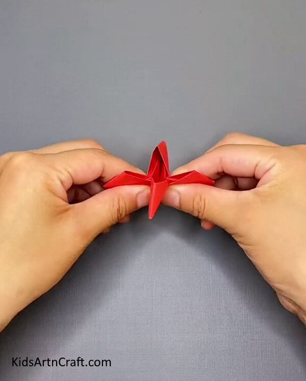 Fold All the Four Sides Of the Craft Paper Inwards- Learn the knack of making an Origami Paper Ninja Star through this craft tutorial. 