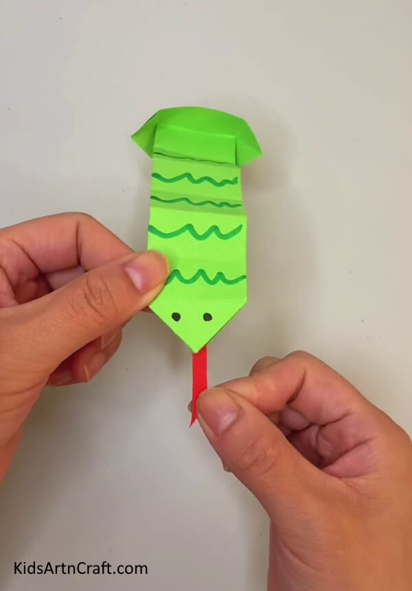 Pasting Tongue Of Snake-.Gain knowledge on How to Form an Origami Snake Activity Guide for Children 