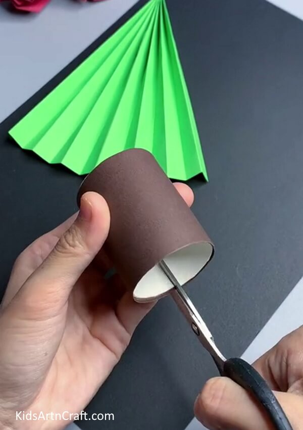 Cut The Trunk Cutout with the scissor to make Paper Christmas Tree Craft