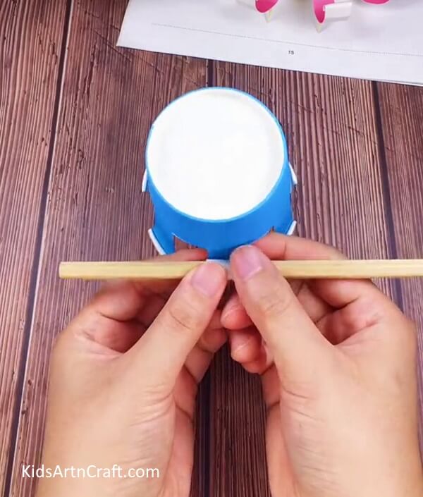 Rolling The Ends Of The Strips-Endeavor to create a Paper Cup Octopus Craft for Infants