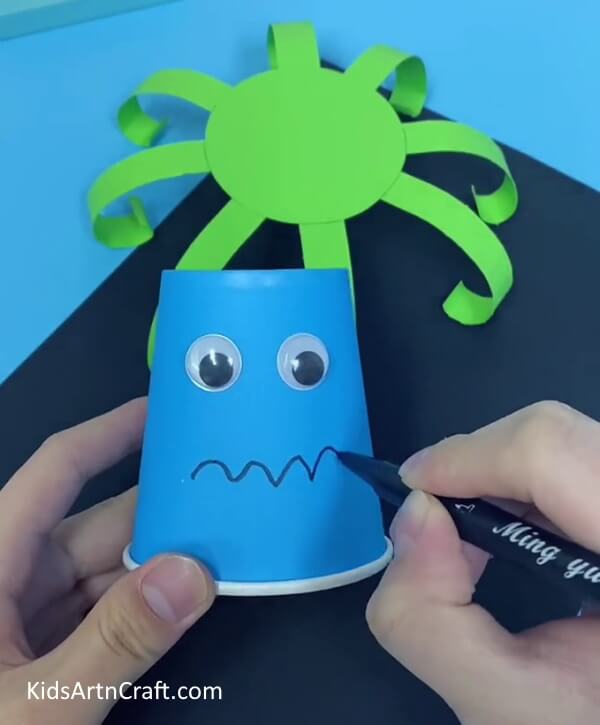 Create An Amusing Facial Expression Using The Marker- Guide your toddler in forming an octopus from paper cups.