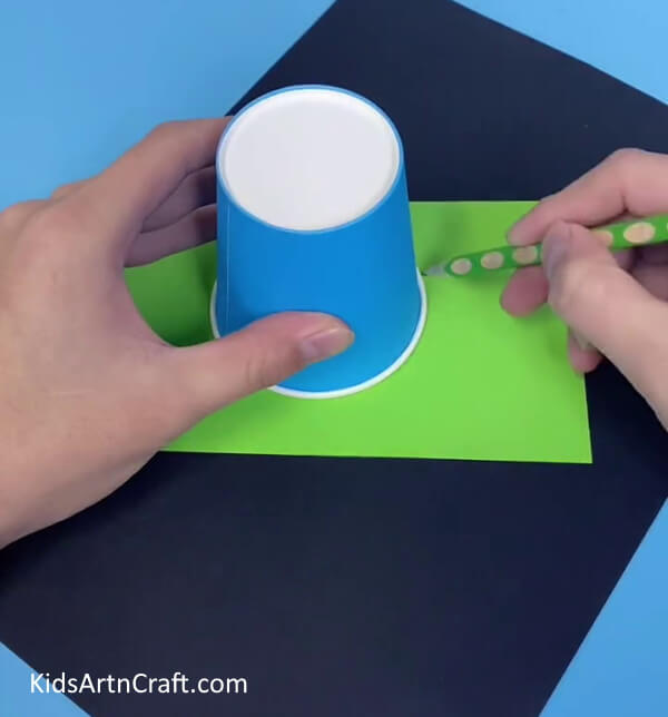 Place The Cup On The Paper- Guide your toddler in creating a paper cup octopus craft.