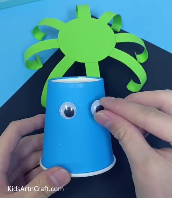Paste Craft Eyes On The Paper Cup- Construct an octopus from paper cups with your toddler.