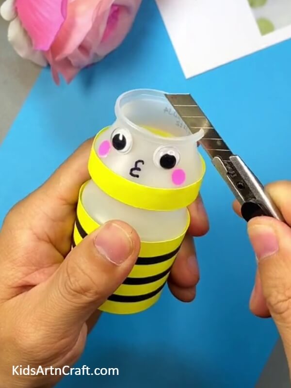 Paste the Antennae on the Bee's Head-An instructional guide on how to make a bee from a plastic bottle for kids