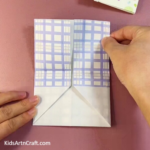 Folding left side of craft paper- Construct a Handy Origami Pocket For Kids