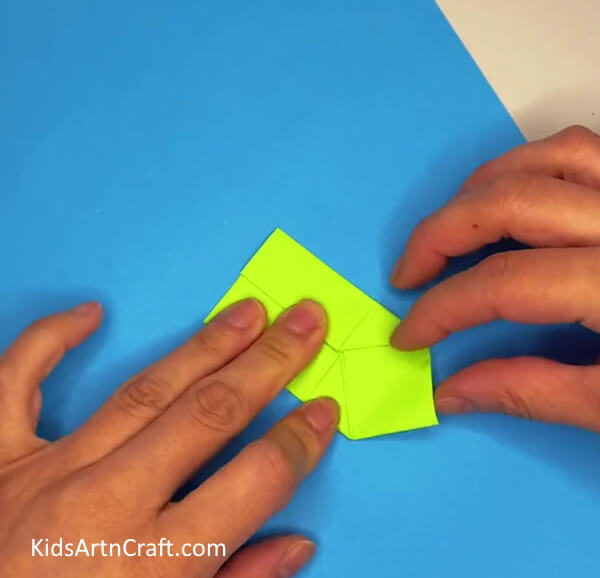Flipping Paper And Folding Sides-An uncomplicated craft project for kids is a moving paper frog.