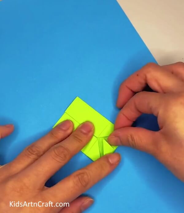 Folding Triangle Downwards- Creating a paper frog that moves is a simple craft idea for kids.