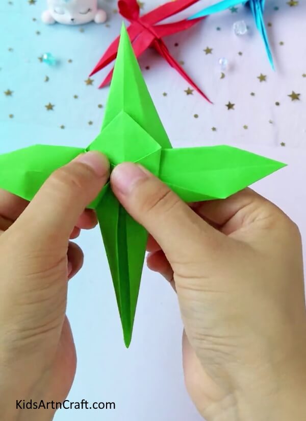 Continue To Fold The Diamond's Both Sides- An easy-to-follow guide to making origami paper dragonflies suitable for kids.
