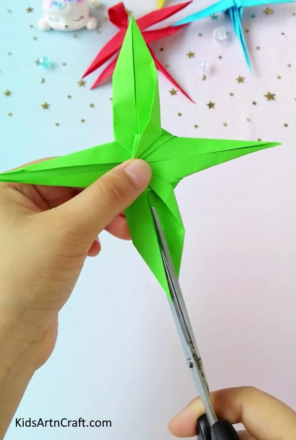 Cutting At The Center To Create Wings- A tutorial for children to learn how to create a dragonfly using origami paper.