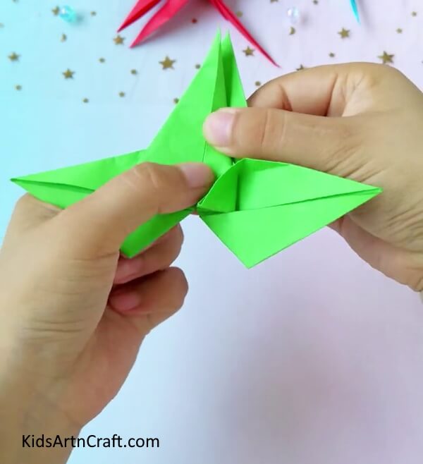 More Creasing To Obtain The Desired Shape- A guide to help kids make a dragonfly from origami paper.