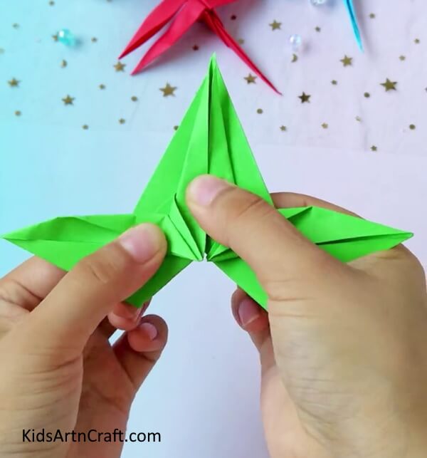 Fold And Hold It Tightly- A tutorial to assist kids in crafting a dragonfly from origami paper.