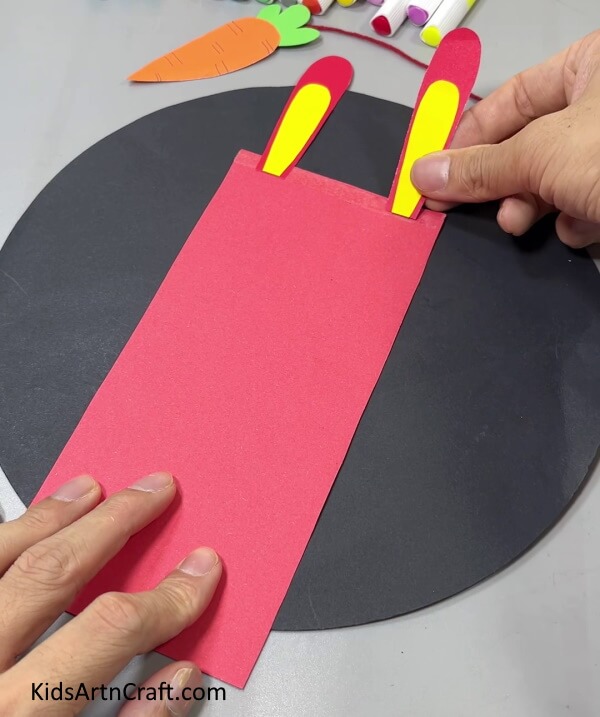 Pasting The Ears- With paper, you can create a bunny and carrot hanging decoration.