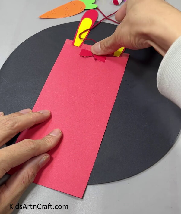 Pasting Red Hourglass Paper - This design utilizes paper to make an easy bunny and carrot hanging craft.