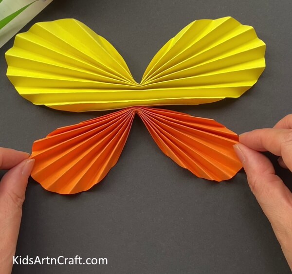 Placing Both The Strips In A Form Of Butterfly - Creating a Paper Butterfly -- A Quick Tutorial for Little Ones 