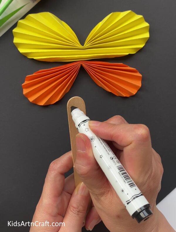 Drawing The Eyes Of Butterfly On An Icecream Stick - Constructing a Paper Butterfly -- A Simple Tutorial for Youngsters 