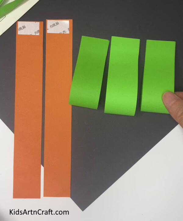 Pasting All Green Strips Crafting Carrots with Paper - A Guide for Kids