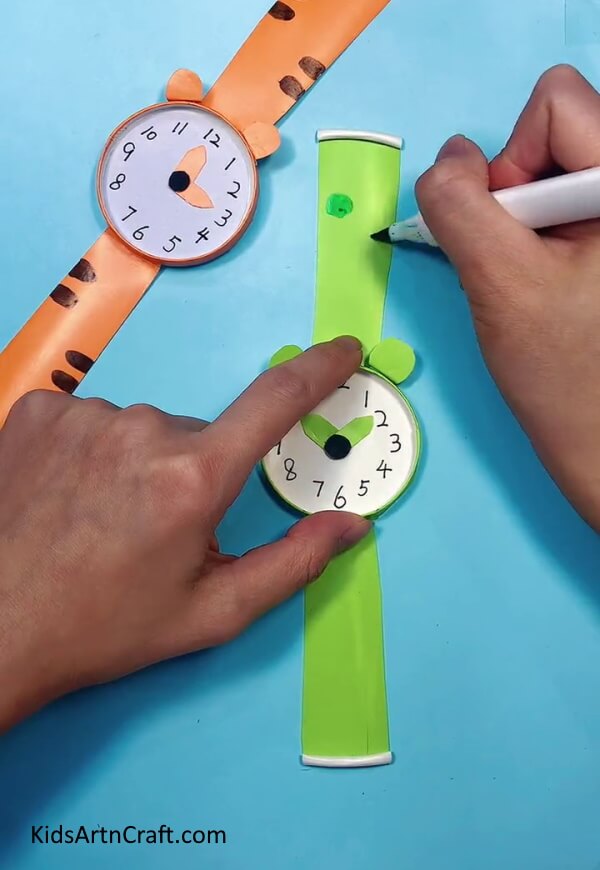 Decorating The Watch An instructional guide on making a paper cup wristwatch for young ones. 