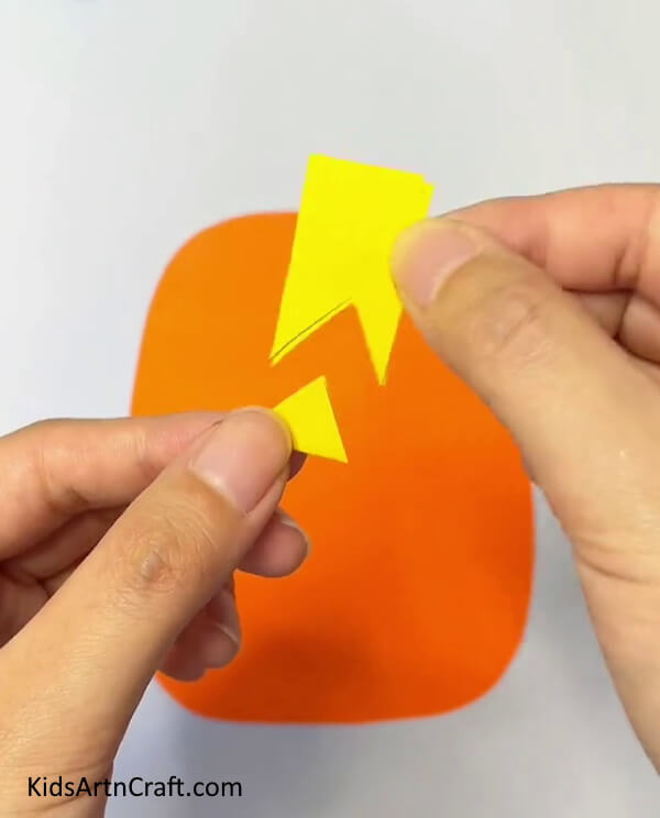 Cut Small Triangles From The Rectangle With Scissors step by step tutorial for kids- A step-by-step manual on how to make Pineapple Paper Projects for little ones 