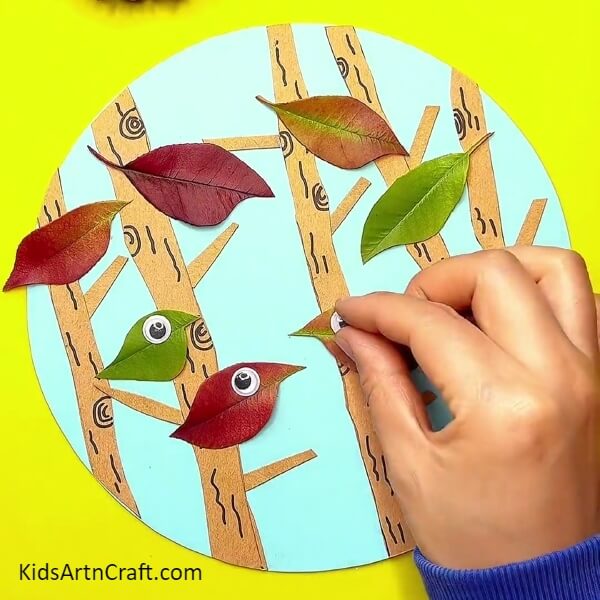 Pasting Googly Eyes- Artistic leaf making for kids through the singing of birds. 