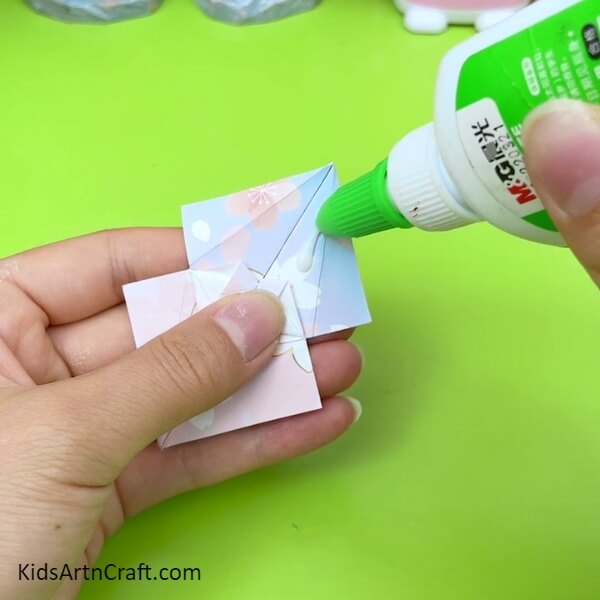 Put Glue On The Opened Side Of The Printed Craft Paper for the Creative Craft - A Fun Origami Umbrella Making Guide For Children 