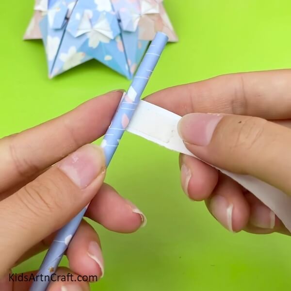 Make stick for the umbrella to look Pretty Origami Umbrella- Creative Instructions To Make An Origami Umbrella For Kids 