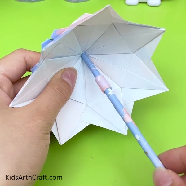 Insert The Stick Into The Umbrella Hole for Origami Umbrella Creative Craft Tutorial For Kids- A Creative Tutorial For Kids To Make An Origami Umbrella 